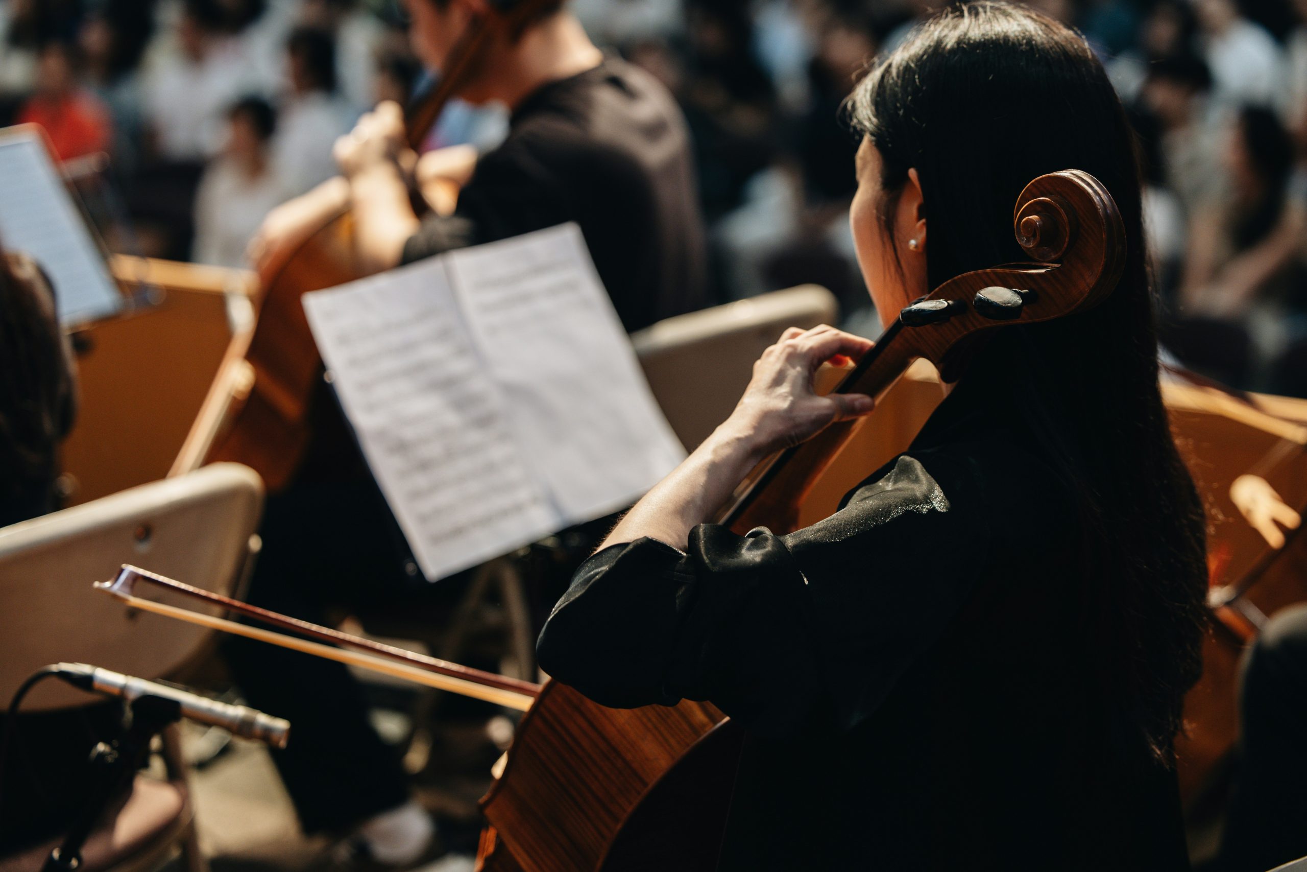 Woman playing the cello with sheet music infront of her
