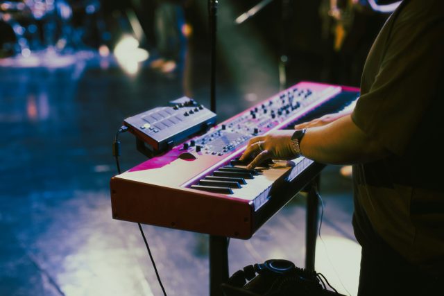 Man playing the keyboard on stage